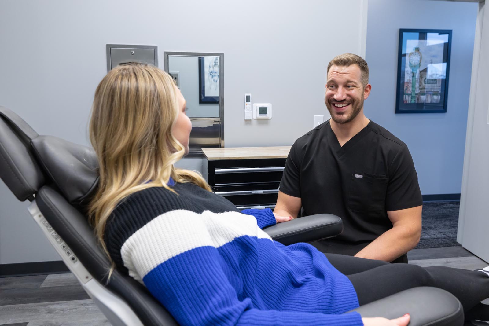 Dr. Chapek talking to a patient in the dental chair.